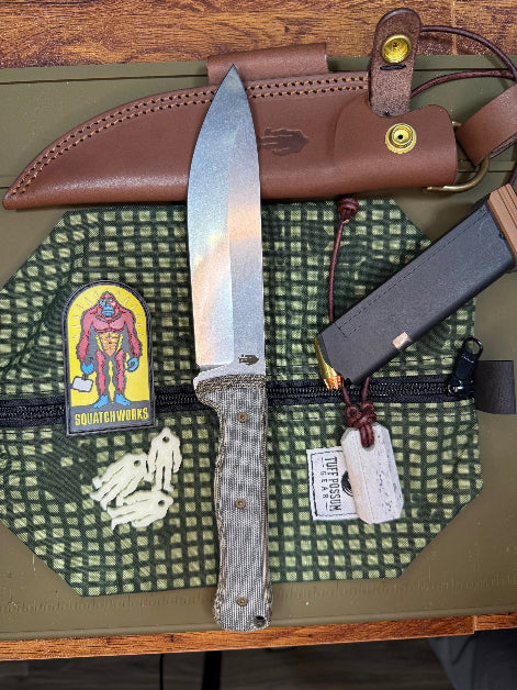 6-inch bushcraft knife with MagnaCut steel blade and durable Micarta handle, offering superior edge retention and grip for rugged outdoor use.