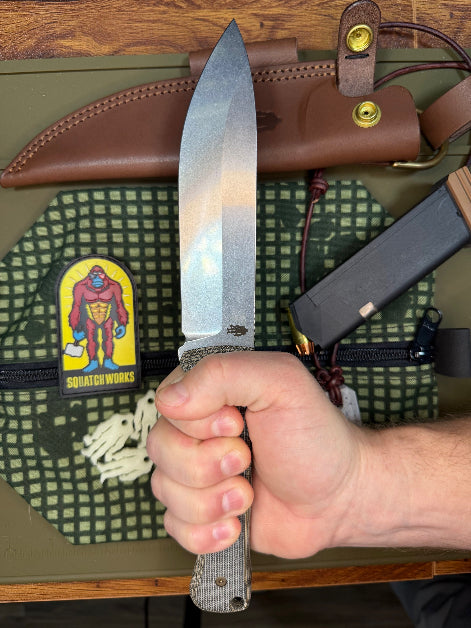 6-inch bushcraft knife with MagnaCut steel blade and durable Micarta handle, offering superior edge retention and grip for rugged outdoor use.