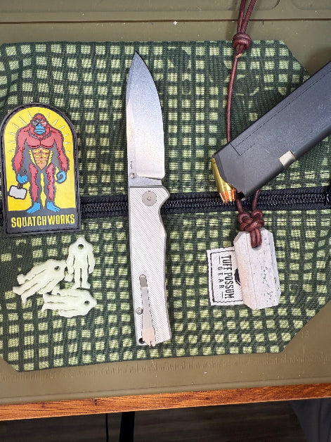 Folding knife with a cryo-treated 14C28N steel blade, featuring a durable Sasquatch-themed pocket clip and designed for everyday carry and outdoor performance.