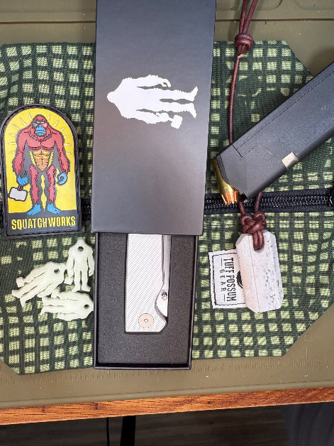 Folding knife with a cryo-treated 14C28N steel blade, featuring a durable Sasquatch-themed pocket clip and designed for everyday carry and outdoor performance.