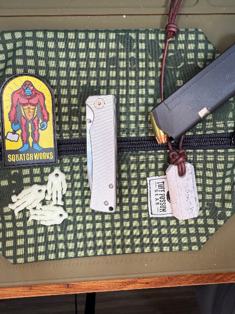 Folding knife with a cryo-treated 14C28N steel blade, featuring a durable Sasquatch-themed pocket clip and designed for everyday carry and outdoor performance.