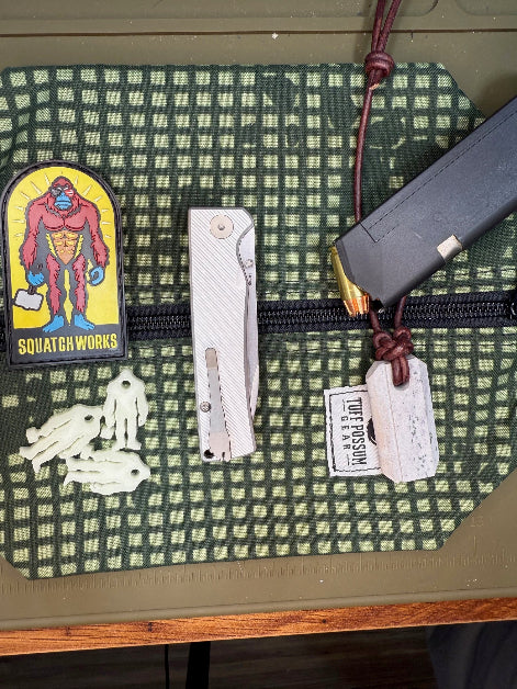Folding knife with a cryo-treated 14C28N steel blade, featuring a durable Sasquatch-themed pocket clip and designed for everyday carry and outdoor performance.