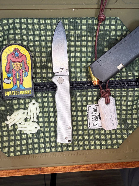 Folding knife with a cryo-treated 14C28N steel blade, featuring a durable Sasquatch-themed pocket clip and designed for everyday carry and outdoor performance.