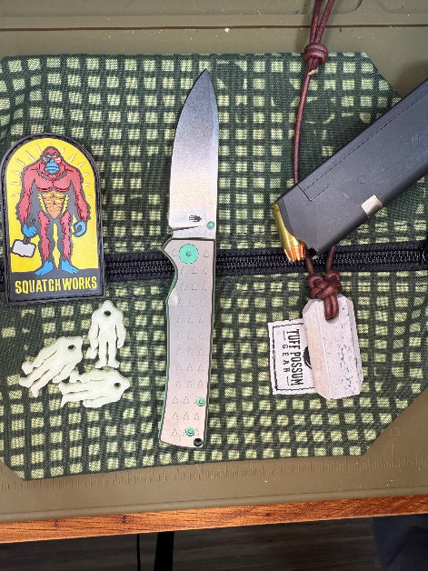 Folding knife with a MagnaCut steel blade, featuring a durable Sasquatch-themed pocket clip, Titanium handles, and designed for everyday carry and outdoor performance.