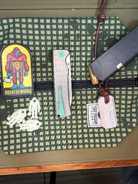 Folding knife with a MagnaCut steel blade, featuring a durable Sasquatch-themed pocket clip, Titanium handles, and designed for everyday carry and outdoor performance.