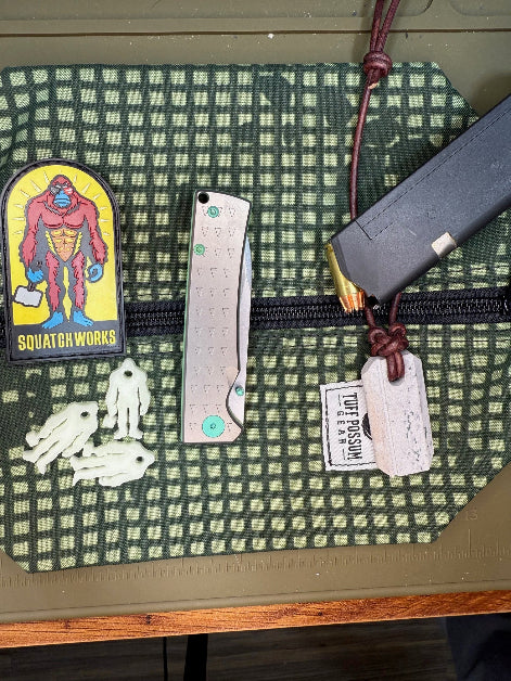 Folding knife with a MagnaCut steel blade, featuring a durable Sasquatch-themed pocket clip, Titanium handles, and designed for everyday carry and outdoor performance.