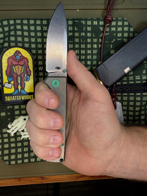 Folding knife with a MagnaCut steel blade, featuring a durable Sasquatch-themed pocket clip, Titanium handles, and designed for everyday carry and outdoor performance.