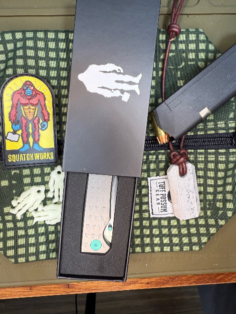 Folding knife with a MagnaCut steel blade, featuring a durable Sasquatch-themed pocket clip, Titanium handles, and designed for everyday carry and outdoor performance.