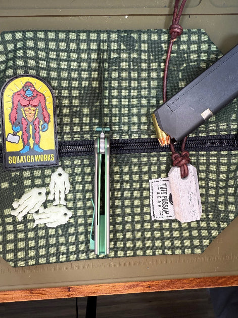 Folding knife with a MagnaCut steel blade, featuring a durable Sasquatch-themed pocket clip, Titanium handles, and designed for everyday carry and outdoor performance.