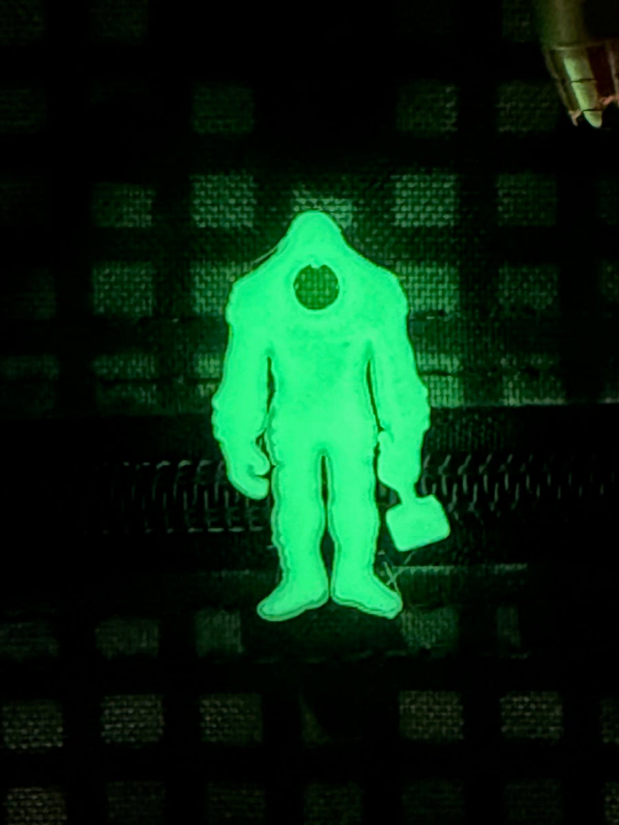 Squatch Works glow-in-the-dark lanyard bead featuring the signature Squatch Works logo, perfect for enhancing visibility and style on your gear.